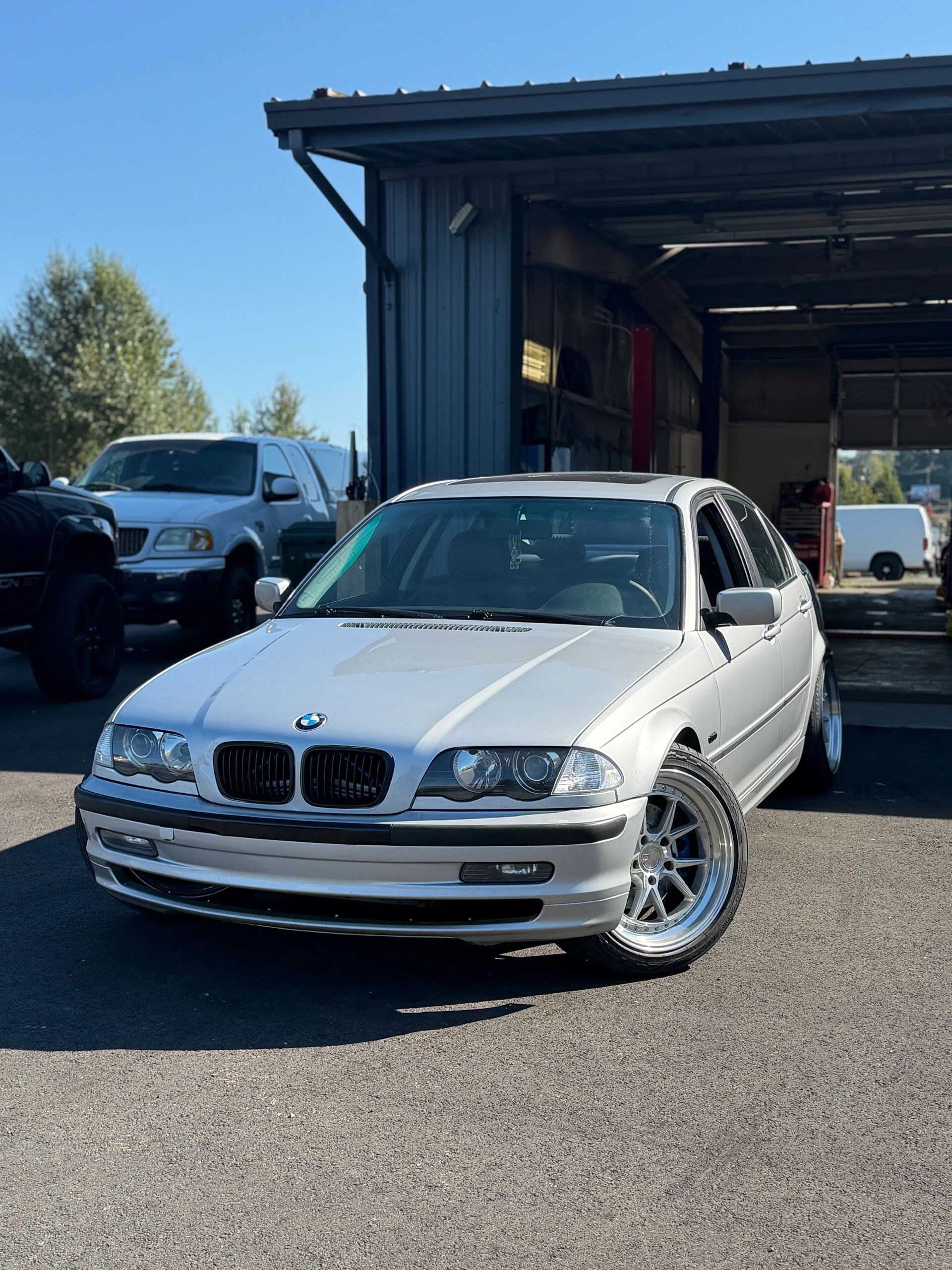 White BMW sedan parked outside Clutch Kick Garage